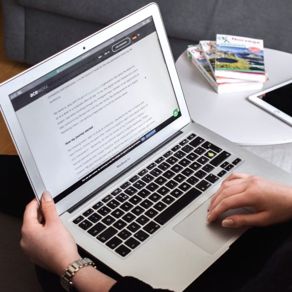 person using macbook air on lap